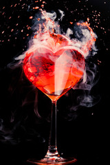 abstract heart shaped red cocktail with splash and ice vapor