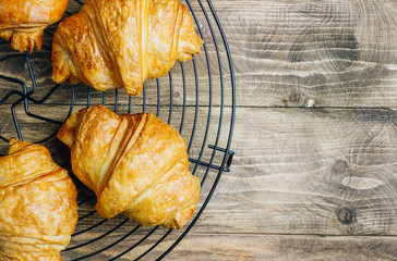 Croissant on rustic wooden table. French breakfast. Top view. Flat lay. Copy space.
