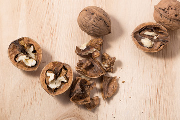 Walnuts isolated on wooden background.