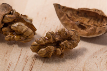 Walnuts isolated on wooden background.