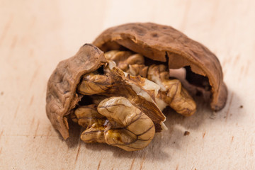 Walnuts isolated on wooden background.