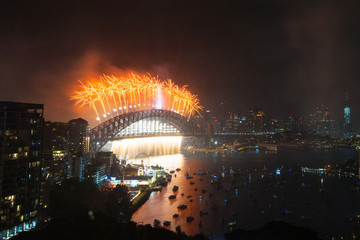 Orange fireworks above Sydney Harbour Bridge for New Year.