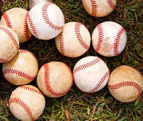 Multiple baseballs in the grass