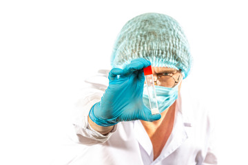 lab technician looks at a test tube of clear liquid, coronavirus