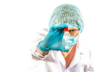 lab technician looks at a test tube of clear liquid, coronavirus