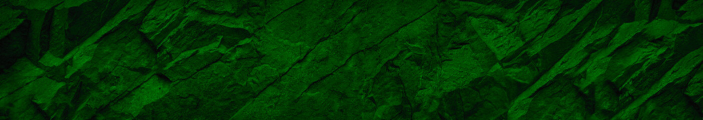 Bright green abstract background. Green grunge banner. Toned rock texture. Mountain stone texture. Close-up. Copy space for your design.