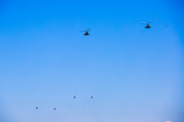 Russian military helicopter during flight in the air, a squadron formation of helicopters