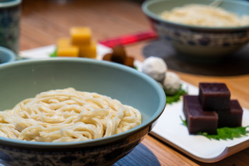 Chinese noodles with traditional pastry on the table