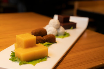 Beijing traditional pastry, such as yellow Pea jelly, Rolling donkey (glutinous rice rolls with sweet bean flour), Steamed rice cakes with sweet stuffing, Kidney Bean Roll on the table, China