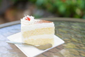 Closeup Milk cake delicious on glass table background, selective focus