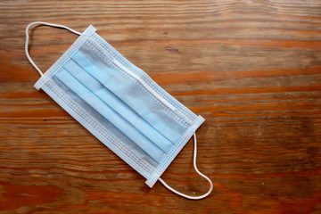 Flat lay of blue infection preventive face mask and space for write wording. Important tools for protecting ourselves from virus infection in Corona virus crisis 2020 and bad air pollution