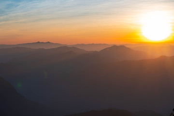 Mountain complex with misty or smoke pollution from wildfire during morning sunrise at the northern region of Thailand.
