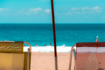 Two beach chairs in front of the sea