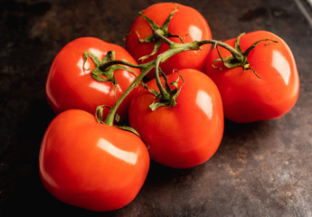 Freshly harvested tomatoes on the rustic background. Selective focus. Shallow depth of field.