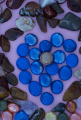 Obraz na płótnie Canvas Vertical valentines heart of blue glass and polished stone.