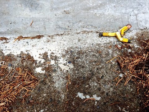 High Angle View Of Broken Figurine On Footpath