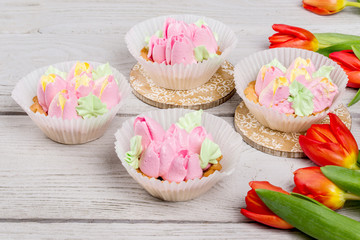 Obraz na płótnie Canvas Flowers tulips dessert cake shot on white wooden background