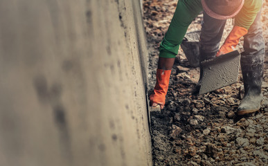 closeup hand worker plastering cement on wall for building house