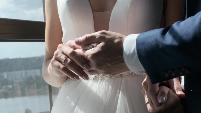 bride and groom holding hands