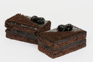 Two pieces of chocolate cakes on a white background