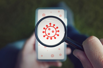 Search for viruses and bacteria on your phone. mobile security concept: hand holding an infected...