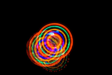 Abstract light painting circles on a black background