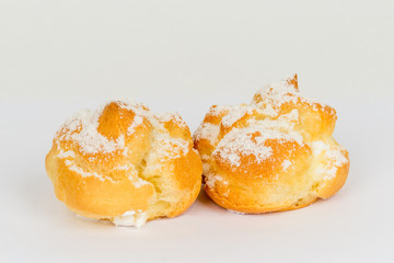 Two custard cakes shot on a white background under tenderloin