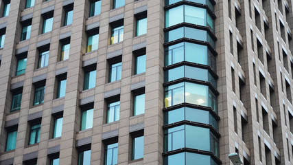 Texture of the facade of an office skyscraper. light in the windows of offices. Glass modern buildings. composition