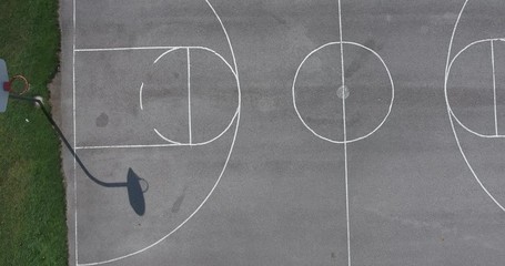 Descending Aerial Towards Empty Concrete Basketball Court in Park 002