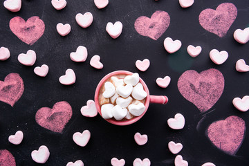 cup of hot chocolate with a heart shaped marshmallow. 
