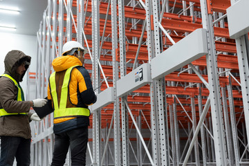 Maintenance technician service in cold warehouse storage, Machinery engineering people checking...
