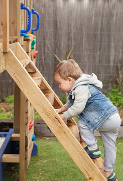 Toddler climbing outdoor cubby backyard 