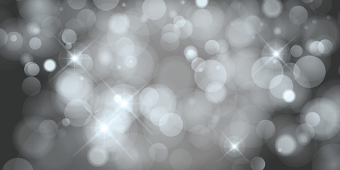 Blurred bokeh light on dark black and white background. Christmas and New Year holidays template.