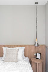 Bedroom Corner with black wooden frame on wooden side table in modern scandinavian style / modern minimal / cozy interior design concept