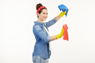 Pretty woman in work-wear uses different coloured rags.