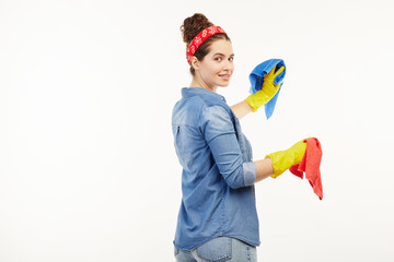 Pretty woman in work-wear uses different coloured rags.