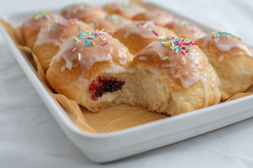 sweet home made Carnival powdered sugar raised donuts with paper streamers
