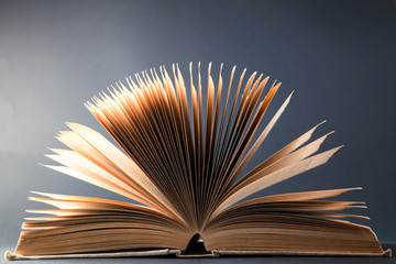 Old opened book on a dark background