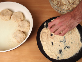 Raw frikadeller put to frying pan. Making Fish Frikadeller Series.