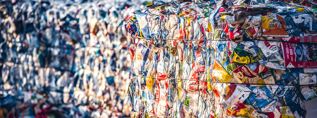 Recycling and storage of waste for further disposal, trash sorting. Picture of recycled plastic waste pressed to bales. Plastic bottles,compressed - obrazy, fototapety, plakaty