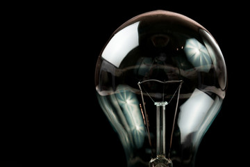Incandescent light bulb on a black background