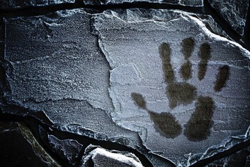 a blurred handprint on a frozen brick wall