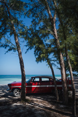 Old cars on a beach in Cuba. 