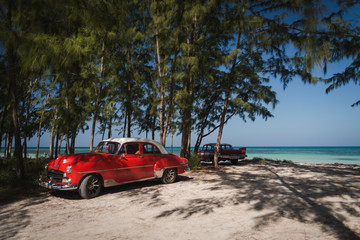 Old cars on a beach in Cuba. 