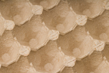 Paper container for quail eggs, close-up texture background.