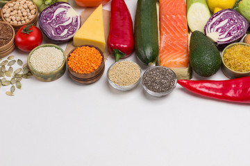 Set of healthy food for balanced nutrition: salmon, cheese, vegetables, beans, nuts, quinoa, bulgur, chickpeas, flax, almond. Sources of omega-3 and proteins.  Flat lay, top view. Copy space.