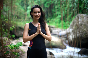 Yoga practice and meditation in nature. Woman practicing near river