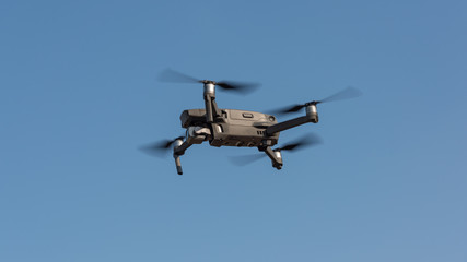 Small gray drone flying in the air