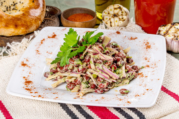 Lobio salad on a white plate shot in the decor.