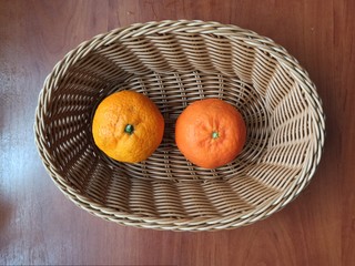 mandarines in wooden basket on wooden table